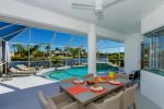 Spacious under truss lanai sitting area with breathtaking view of the pool and water basin canal